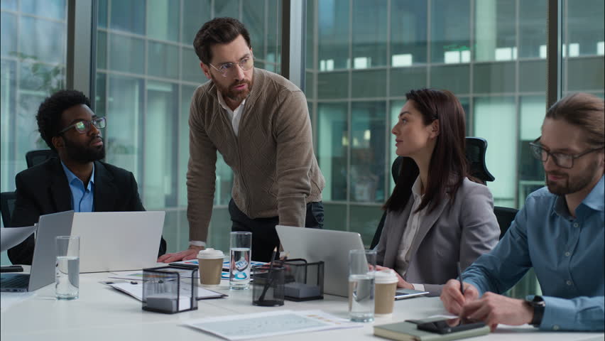 Multiracial business group multiethnic women men businesspeople office meeting briefing Caucasian leader talking discussing planning African American Indian employes team coworkers negotiation startup