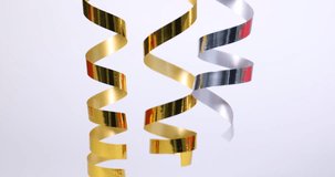Shiny serpentine streamers on white background, closeup - Powered by Shutterstock - Get 15% off with code: PIKWIZARD15