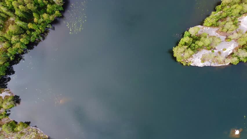 Russia, Lake Ladoga, Koyonsaari. View of the coast of the island in a cold lake. Beautiful nature of the Republic of Karelia. Panoramic view from the height of the Ladoga skerry islands. 4K