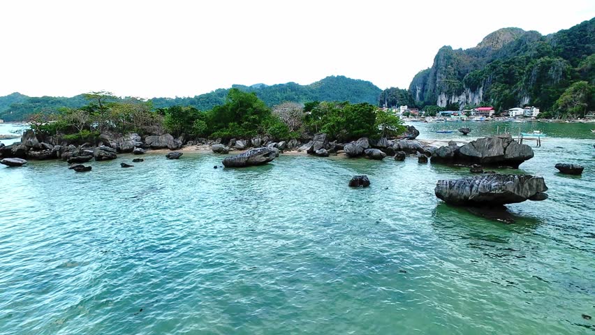Shallow waters and coastal mangroves near El Nido town, Palawan from aerial view