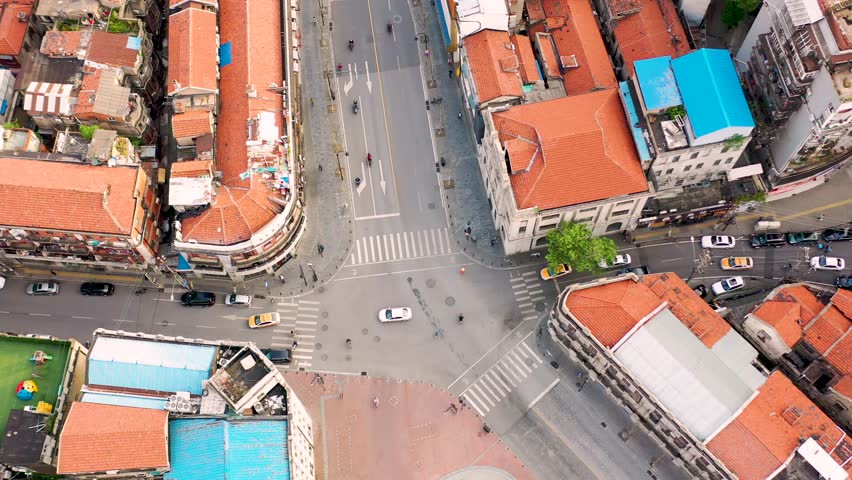 Witness the historic Hankou Concession intersection in Wuhan, showcasing colorful rooftops, busy streets, and a blend of architectural styles.