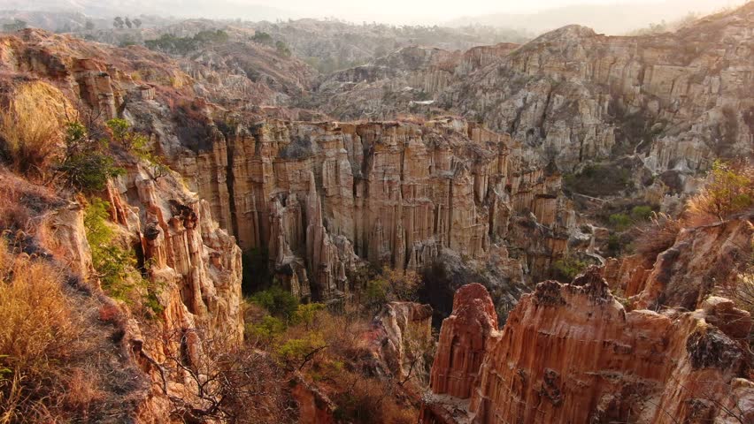 Journey through the striking formations of Yuanmou Tulin Ghost Wolf Valley, showcasing majestic cliffs and unique geological patterns in Yunnan. Experience the stunning natural beauty and rich colors.