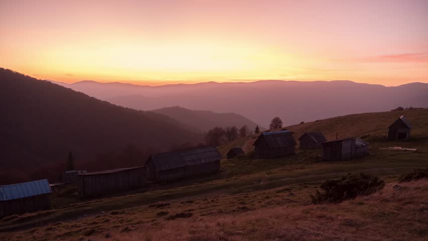 Stunning sunset time-lapse of traditional wooden village in the Carpathian Mountains near Hoverla. Glowing sky and rolling hills ideal for travel promos, tourism ads, or nature videos.
