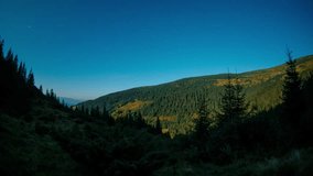 Stunning night time-lapse of forested Carpathian Mountains under full moon. Stars glimmer as moonlight illuminates ridges and valleys. Ideal for nature, astronomy, or travel projects. - Powered by Shutterstock - Get 15% off with code: PIKWIZARD15