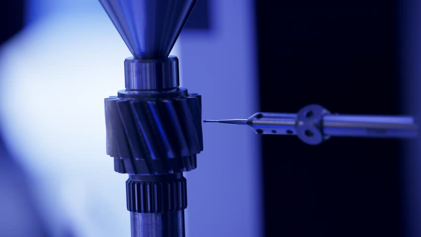 Cnc coordinate measuring machine analyzing gear with precision probe.