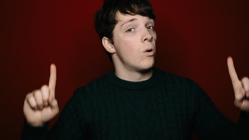 Young attractive student and sale. Red background.