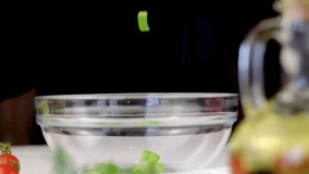 Fresh green bell pepper slices falling into glass bowl for a salad preparation - Powered by Shutterstock - Get 15% off with code: PIKWIZARD15