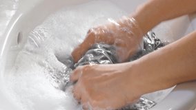 Washing clothes by hands in the basin. - Powered by Shutterstock - Get 15% off with code: PIKWIZARD15