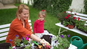Joyful gardening moments shared between mother and daughter - Powered by Shutterstock - Get 15% off with code: PIKWIZARD15