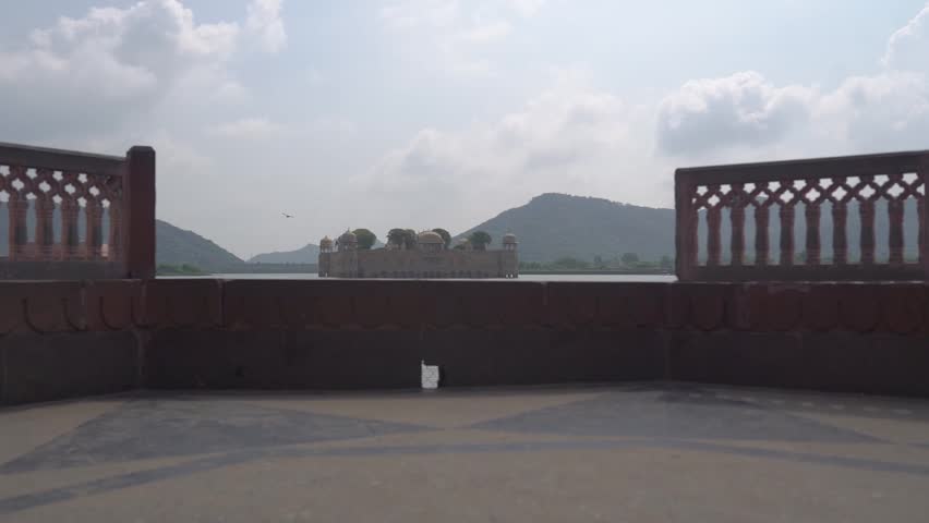 Smooth pedestal gimbal shot of Jal Mahal, the stunning water palace located in the middle of Man Sagar Lake in Jaipur, Rajasthan. Captures the upward motion of the iconic structure surrounded by water
