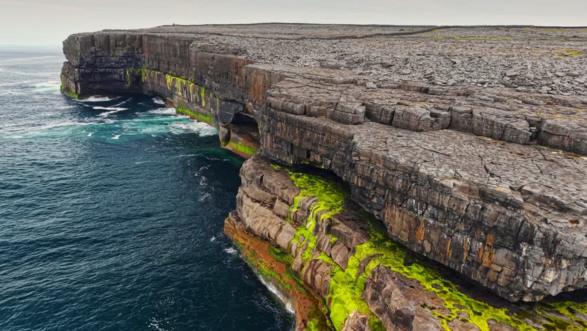 Aerial shot of stunning natural landscapes of Aran Islands with breathtaking cliffs and vibrant coastal views during serene day of adventure. The Arans, Ireland, Galway Bay 