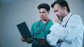 Two doctors discuss patient care using a laptop and advanced AI systems, analyzing medical data for accurate diagnosis and treatment planning. - Powered by Shutterstock - Get 15% off with code: PIKWIZARD15
