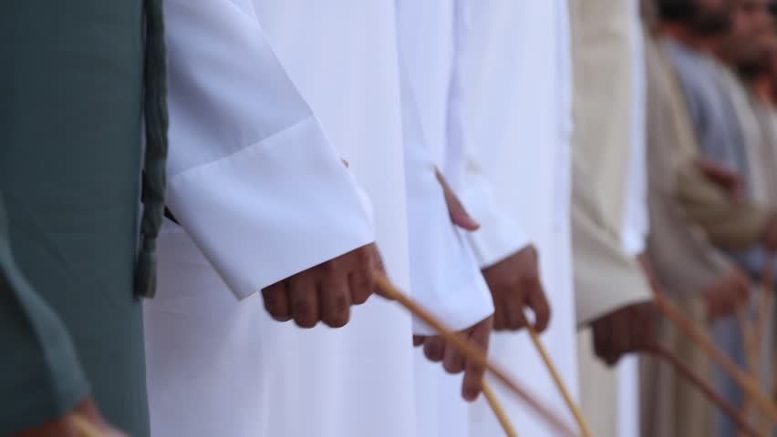Traditional Emirati al Ayala male dance, cultural UAE heritage. Closeup on hands.