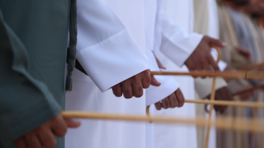 Traditional Emirati al Ayala male dance, cultural UAE heritage. Closeup on hands.