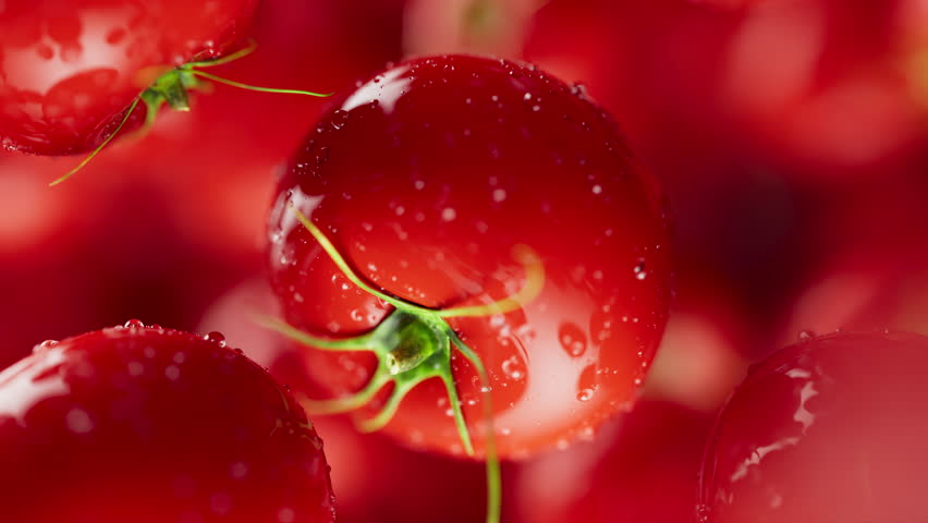 Animation of a group of tomato. Many tomatoes slowly rotate in the background in space. Horizontal composition. Defocus. Close-up.