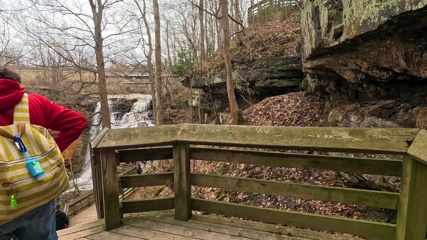 Exploring Brandywine Falls in Cuyahoga National Park during springtime with visitors admiring nature