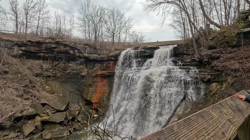 Exploring Brandywine Falls in Cuyahoga Valley during a tranquil afternoon. Witness the beauty of Brandywine Falls as water cascades over the rocks in Cuyahoga Valley. Enjoy nature