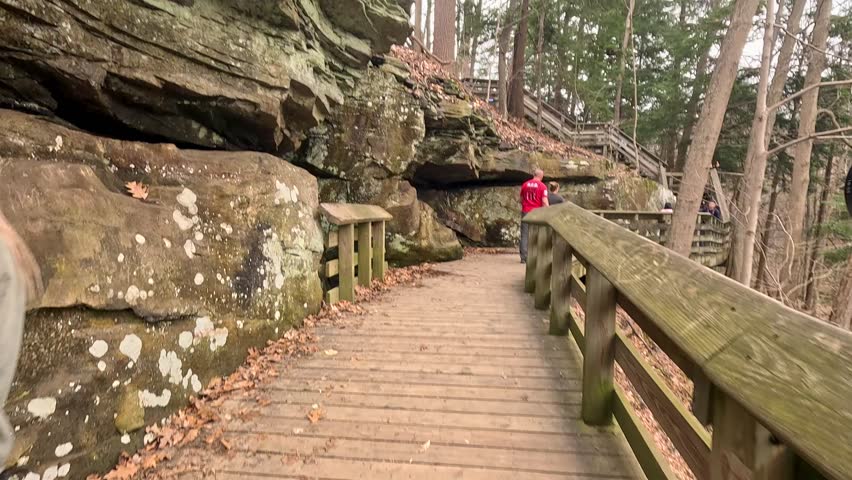 Explore the natural beauty of Brandywine Falls in Cuyahoga Valley National Park on a trail with stunning views. Visitors enjoy the scenic trail leading to Brandywine Falls, surrounded by trees and nat