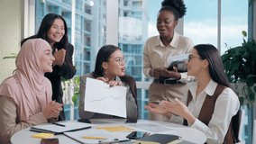 Excited happy multiethnic women females team girls African American Caucasian Japanese Muslim hijab Arabian businesswomen analyzing statistic document paper graph celebrating success startup in office - Powered by Shutterstock - Get 15% off with code: PIKWIZARD15