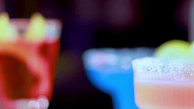 A vibrant display of cocktails with sugar-rimmed glasses and citrus garnishes in a lively setting. - Powered by Shutterstock - Get 15% off with code: PIKWIZARD15