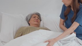 Asian daughter put blanket on senior mother while sleep on bed at home. Attractive young woman take care and support elderly mature sleeping mom lying down in bedroom, resting for health care in house - Powered by Shutterstock - Get 15% off with code: PIKWIZARD15