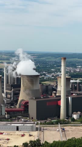 aerial view of the fossil fuel energy industry, climate change, heavy industry, chimney, water towers.Vertical video