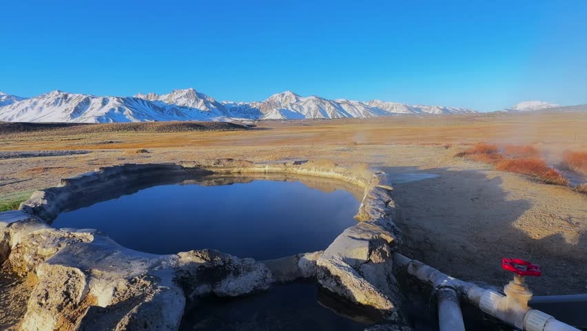 Winter early morning blue sky natural hot springs hot tub soak sunny sky snow covered Mammoth Mountain Minarets aerial drone Convict Canyon Hilltop Whitmore Wild Willys Hot Springs peaceful steam