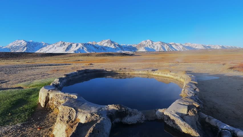 Winter early morning blue sky natural Hilltop Whitmore Wild Willys Hot Springs hot tub soak sunny sky snow covered Mammoth Mountain Minarets aerial drone Convict Canyon peaceful steam static