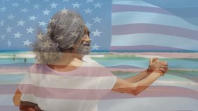 Senior man leading beach dancing with woman under clear American flag overlay in travel advertising. Romance, serenity, movement, portrait, outdoor, elegance, connection - Powered by Shutterstock - Get 15% off with code: PIKWIZARD15