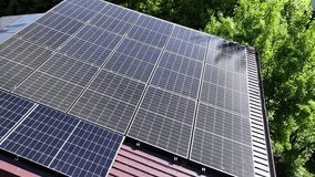 Solar panel rooftop on private home with green surroundings, close up aerial orbit view - Powered by Shutterstock - Get 15% off with code: PIKWIZARD15