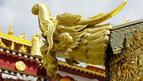 A golden mythical ornament crowns a Tibetan temple roof—highlighting symbolic carvings, cultural craftsmanship, and the sacred elegance of monastery architecture. - Powered by Shutterstock - Get 15% off with code: PIKWIZARD15