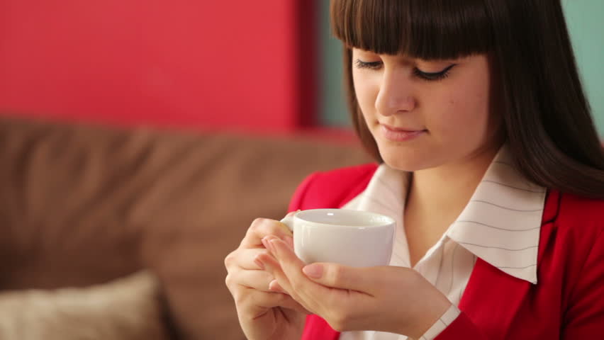 Woman sitting at cafe with cup of coffee

