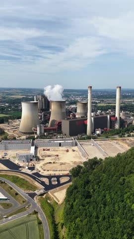 aerial view of the fossil fuel energy industry, climate change, heavy industry, chimney, water towers.Vertical video