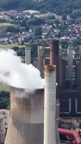aerial view of the fossil fuel energy industry, climate change, heavy industry, chimney, water towers.Vertical video