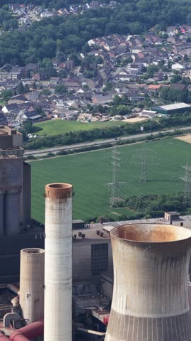aerial view of the fossil fuel energy industry, climate change, heavy industry, chimney, water towers.Vertical video
