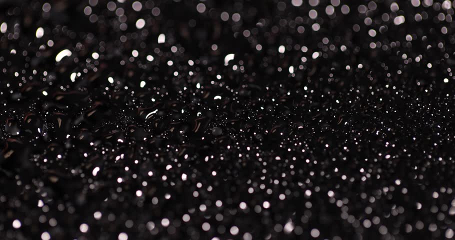 black wet glass covered with droplets, black surface close up