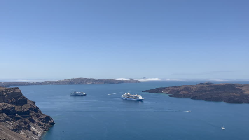 Cruise liners sail in the Aegean Sea below Santorini, with stunning Greek Islands in the background. Perfect for Mediterranean travel, tourism, and cruise industry visuals.