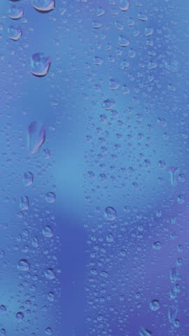 Raindrops gently slide down a window during a gloomy evening, creating a calm and moody ambiance. Perfect for conveying solitude, reflection, peaceful moments, or emotional storytelling.