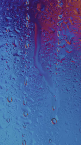 Raindrops gently slide down a window during a gloomy evening, creating a calm and moody ambiance. Perfect for conveying solitude, reflection, peaceful moments, or emotional storytelling.
