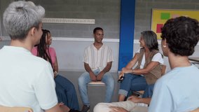 Group therapy session addressing mental health and wellbeing. Patients and therapist discussing during a group therapy session - Powered by Shutterstock - Get 15% off with code: PIKWIZARD15