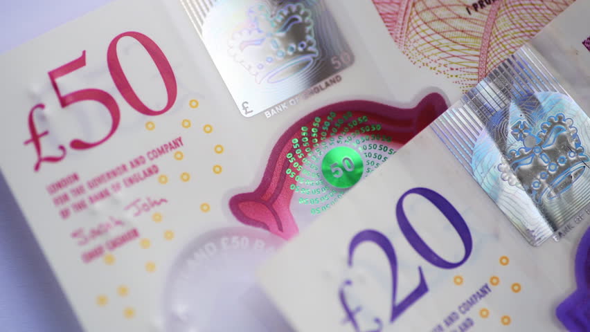 Macro close up of Pound Sterling bank notes from 50 down to  5 Pounds. 