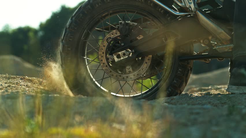 Super Slow Motion Shot of an Off-Road Motorcycle Spinning Its Rear Wheel and Throwing Dirt Into the Air. Captured at 1000fps to Highlight Power, Motion, and Explosive Terrain Impact. Speed Ramp Effect