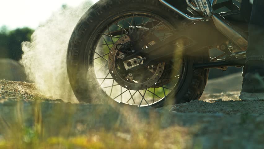 Super Slow Motion Shot of an Off-Road Motorcycle Spinning Its Rear Wheel and Throwing Dirt Into the Air. Captured at 1000fps to Highlight Power, Motion, and Explosive Terrain Impact. Speed Ramp Effect