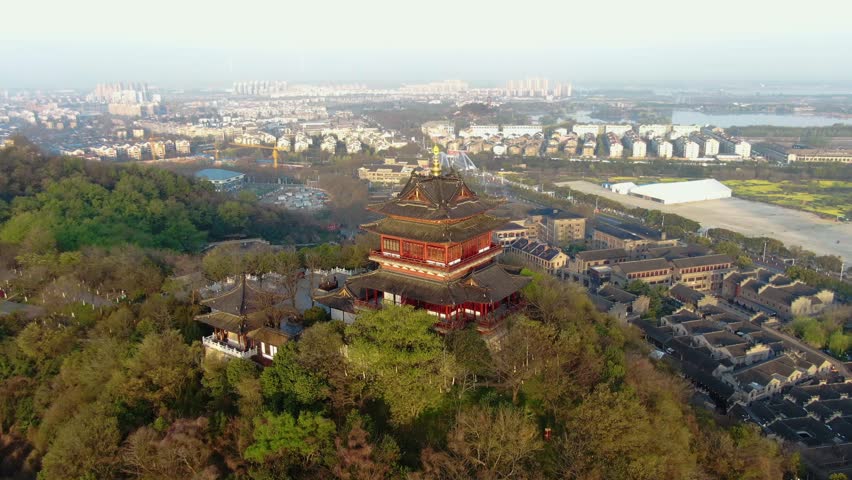 Experience the stunning aerial view of Yuntai Pavilion, a historic landmark situated on Xijindu Ancient Street in Zhenjiang, showcasing the beauty of traditional architecture and nature.