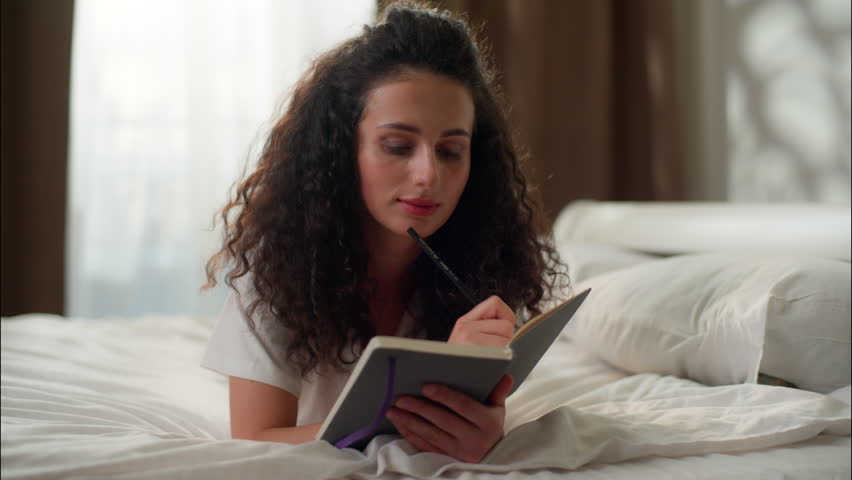 Woman girl dreaming writing notebook in bed Caucasian female teen thoughtful write diary thoughts ideas in bedroom student planning tasks businesswoman notes copybook morning studying home education