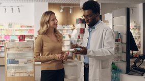 Pharmacist doctor help customer medicine recommendation advice buying pills vitamins in pharmacy health care products African American man Caucasian woman buy medication drugstore medical consultation - Powered by Shutterstock - Get 15% off with code: PIKWIZARD15
