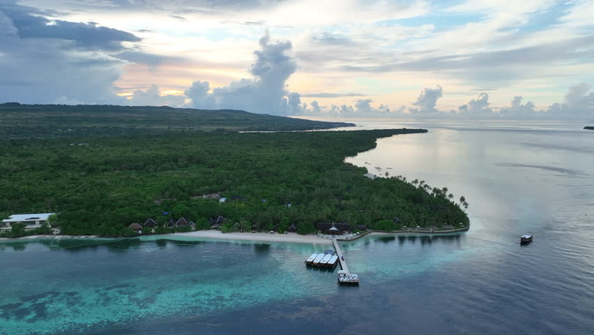 The scenic Wakatobi Resort is surrounded by serene seas at sunrise in Wakatobi National Park, Indonesia. This area is a popular destination for divers and snorkelers due to high marine biodiversity.