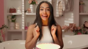 Excited happy Latina woman smiling teen girl Hispanic consumer buyer open box birthday gift shock surprise home parcel amazing miracle wonder new present beauty fashion shopping in pink candy bathroom - Powered by Shutterstock - Get 15% off with code: PIKWIZARD15