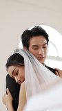 Asian bride and groom embrace or hug warmly indoors on celebrating wedding day, showing love and closeness.	 - Powered by Shutterstock - Get 15% off with code: PIKWIZARD15