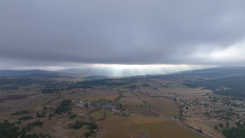 Aerial Landscape of Rugged Highlands, Fields, village and Moody Overcast Sky
